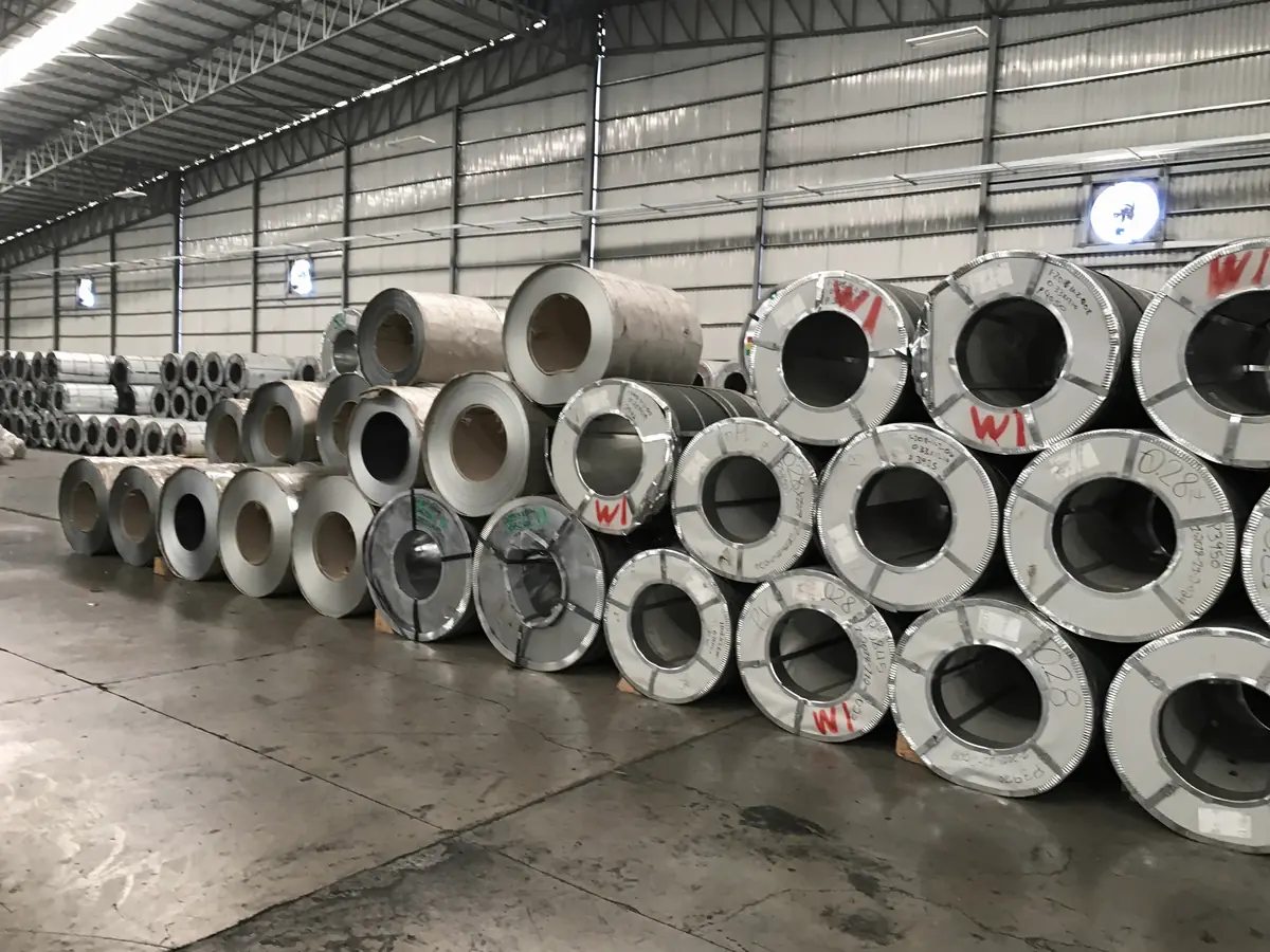 Illustrative image of rows of steel coils in a warehouse (not Jayesh Steel stock)