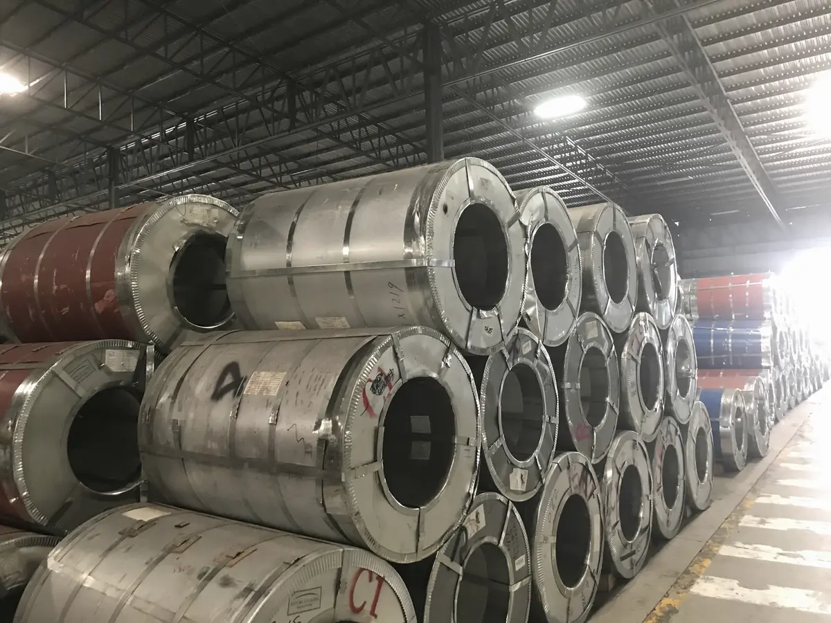 Illustrative image of bright steel coils stacked in a warehouse (not Jayesh Steel stock)