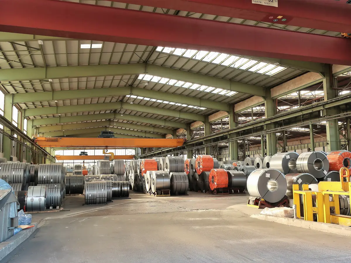 Illustrative image of a steel stockholder's crane hall with coils (not Jayesh Steel premises)