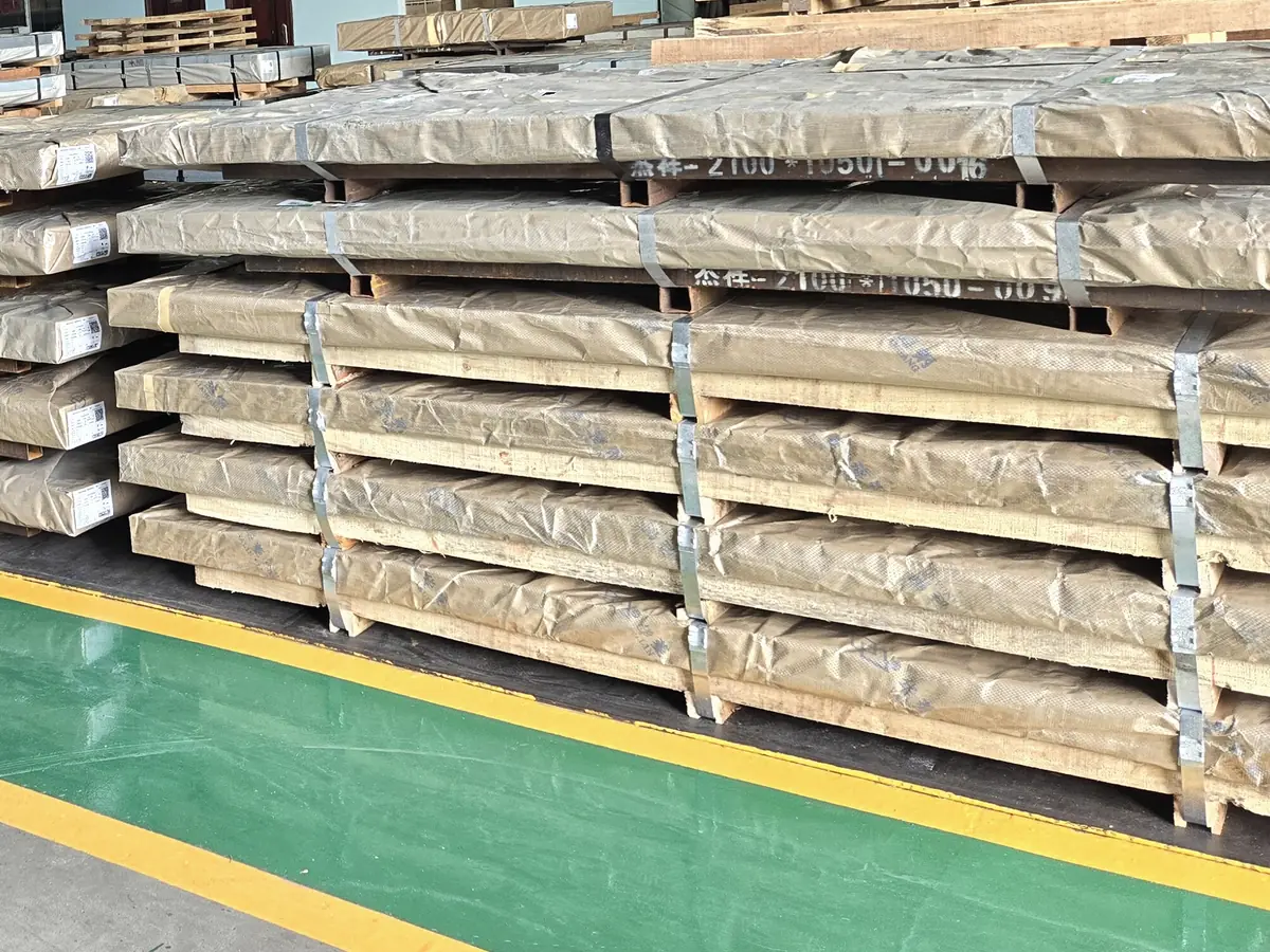 Illustrative image of packed steel plate on timber bearers in a warehouse (not Jayesh Steel stock)